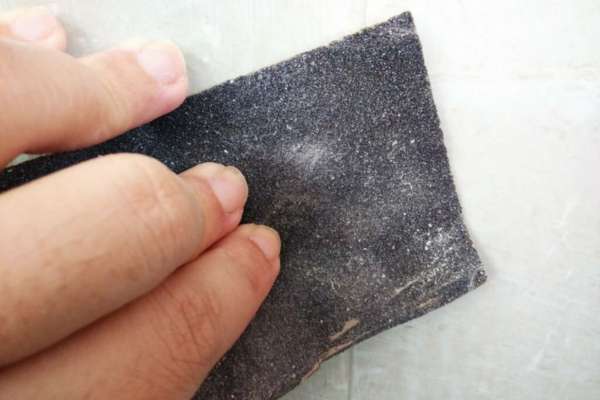 Once The First Coat Is Dry, Use A Fine-Toothed Sandpaper To Smooth Out Any Imperfections